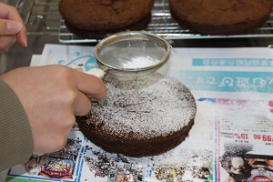 ケーキにパウダーシュガーをふりかけて